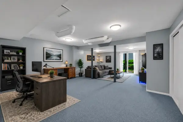 Walkout basement set up as a home office with sitting area and slider to the yard